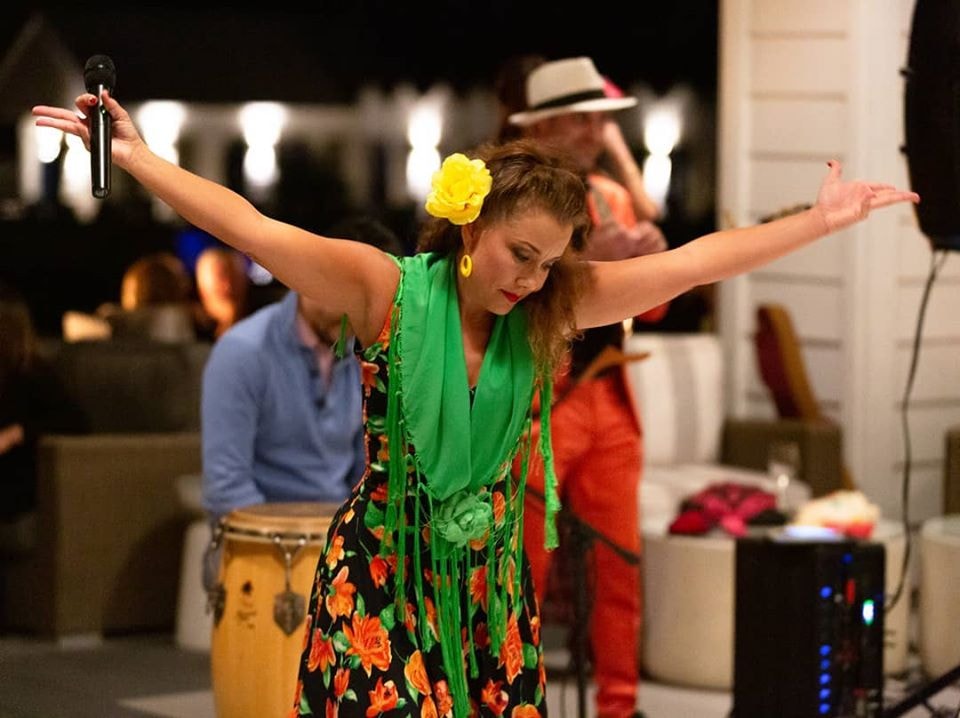 Flamenco dancer performing with arms raised