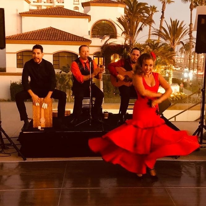 Flamenco dancer in red dress with live band